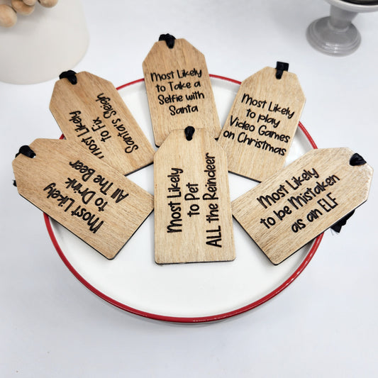 Wooden Christmas tags with humorous text on a white plate